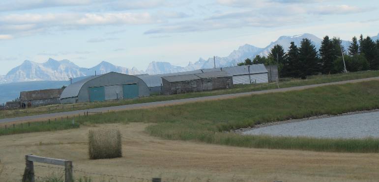building in Hillspring, Alberta with Canadian Rockies
