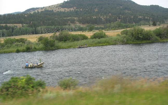 Drift boats and fly fishermen on the Madison River