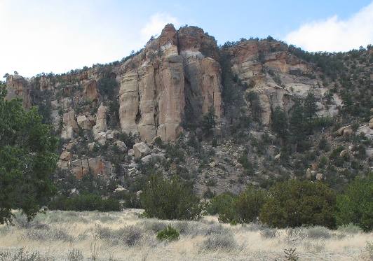 Hoodoos, desert varnish and talus slopes all visible on this sandstone cliff