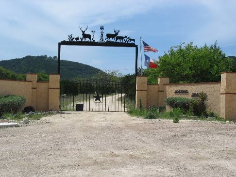 Impressive masonry and iron work adorn this Hill Country Ranch Gate