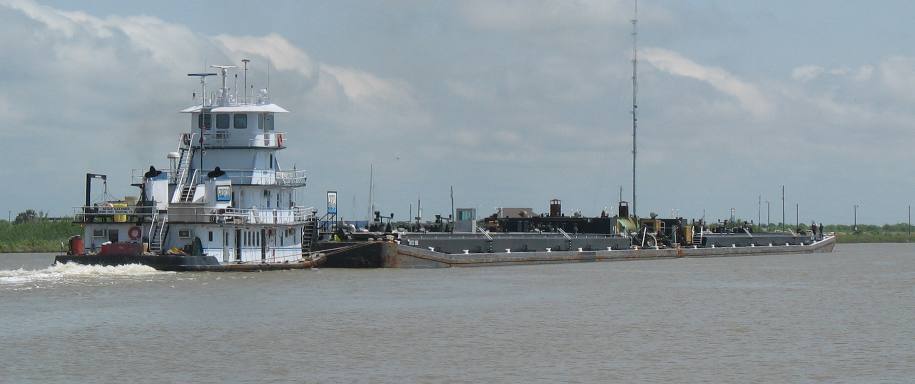 Tug with loaded barges in intercoaster waterway near Matagorda, Texas