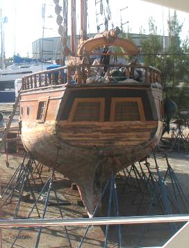 Old sail boat next to Smilin Time at Stock Island boat yard