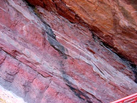 Red sandstone and siltstone that form the wall on the south side of Red Rocks Ampitheatre