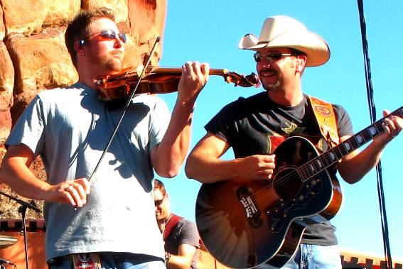 Craig Campbell having fun with his fiddle player on stage at Red Rocks Ampitheatre