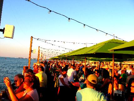 Evening crowd on sunset pier waiting for the sunset