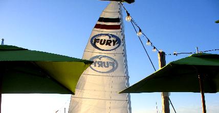 Fury's sunset sail catamaran passing close by Sunset Pier