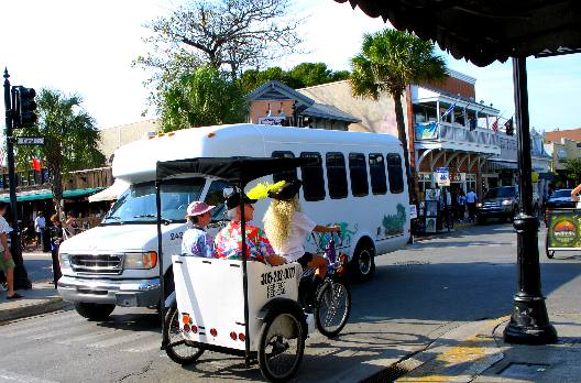 Passengers in Key West pedicab heading down Duval Street