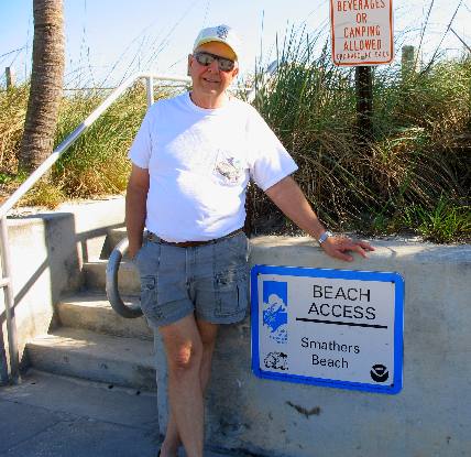 Mike Hendrix and Beach Access sign for Smathers Beach in Key West
