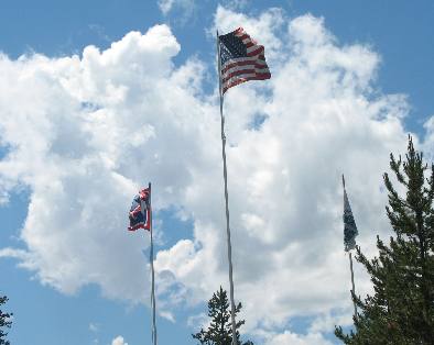Three Flags fly at the entrance to Flagg Ranch