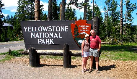 Mike & Joyce Hendrix in front of the Yellowstone National Park entrance sign located at the south entrance