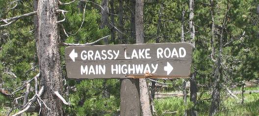 Sign at Flagg Ranch directing traffic to the main highway or Grassy Lake Road in John D. Rockefeller Jr. Memorial Parkway