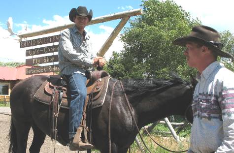 Cowboys working with pack animals in the Heart 6 Guest Ranch corrals off Buffalo Valley Road