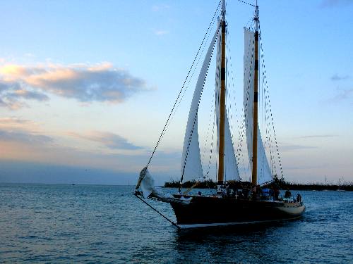 The ultra modern and fast sailing schooner America 2 sailing past Sunset Pier at Ocean Reef Resort in Key West
