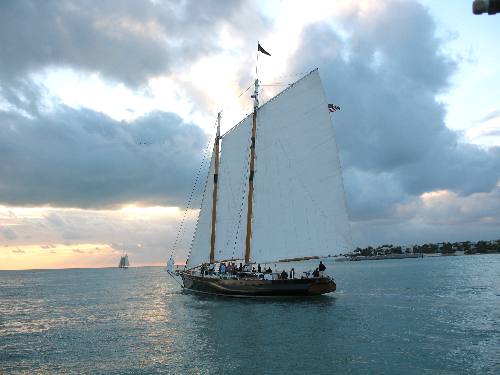 Fast sailing schooner America 2 sailing past Sunset Pier in Key West