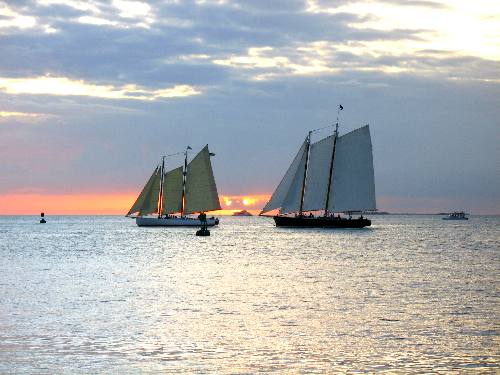 Sailing Schooner Adirondack III and America 2 passing by Sunset Pier at Ocean Key Resort in Key West during a sunset cruise