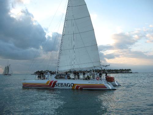 Sebago sunset cruise catamaran with the sailing schooner Appledore and Sunset Key in the background