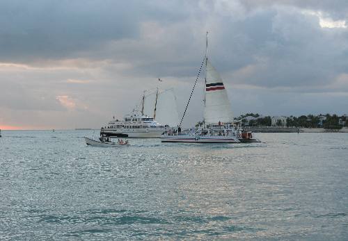 One of the Fury Catamarans, the Yankee Freedom returning from Ft Jefferson in the Dry Tortugas and the white sails belong to the schooner America 2