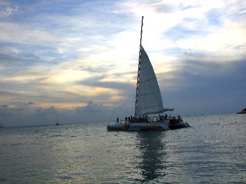 One of the Sebago catamarans sailing into the sunset off Key West