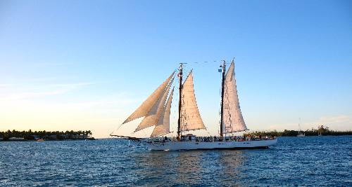 The schooner Western Union sailing off Key West with Sunset Key and Wisteria Island in the background