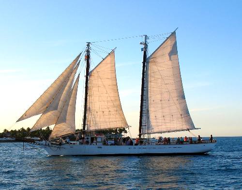 The schooner Western Union sailing off Key West with Sunset Key in the background