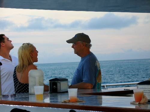 Mike chatting with a Navy couple who were enjoying an Anniversary on the Party Cat Sunset Cruise in Key West