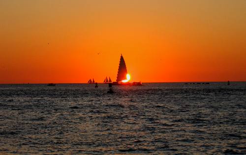 A truly beautiful Key West sunset complete with a Sebago sail partially eclipsing the sun