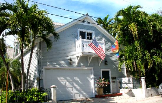 Tropical palm trees and the American Flag decorate this Key West landscape