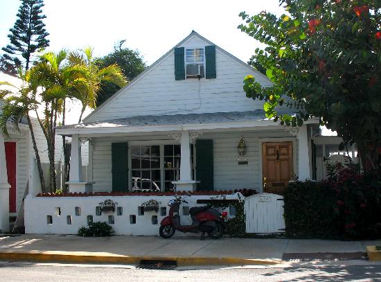 Private residence along Whitehead Street with blooming African tulip tree in yard