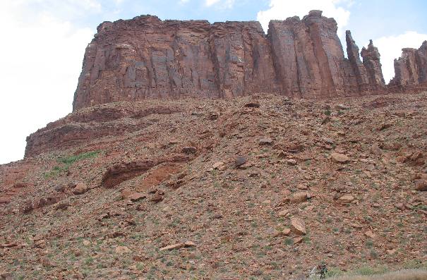 Talus slope with desert varnish on sandstone cliff face