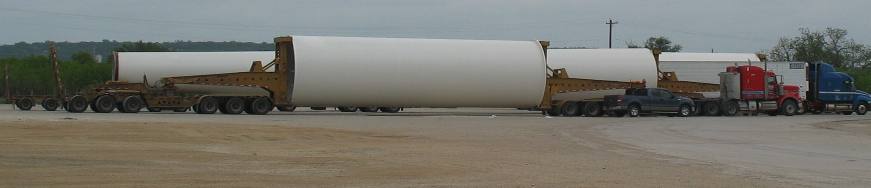 Base section & top section of wind generator towers at truck stop in Junction, Texas