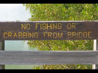 No Fishing or Crabbing from Bridge sign on Sanibel Island, Florida